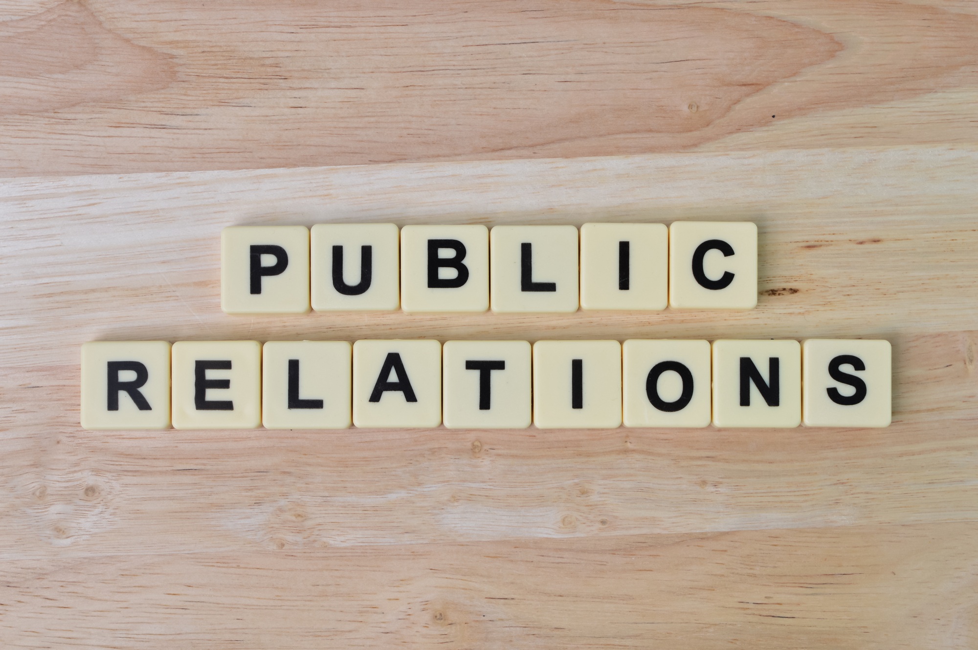 Scrabble letters with text PUBLIC RELATIONS. Top view.